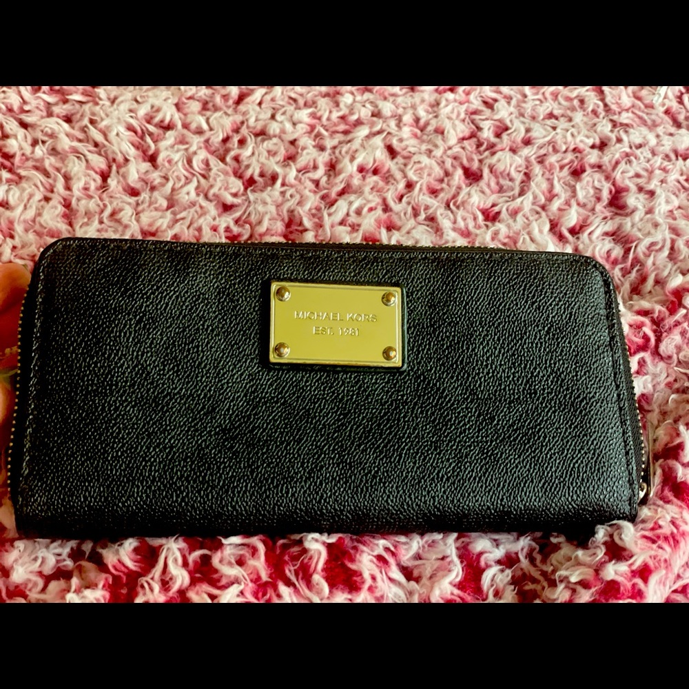Gently loves black and silver large MK wallet.